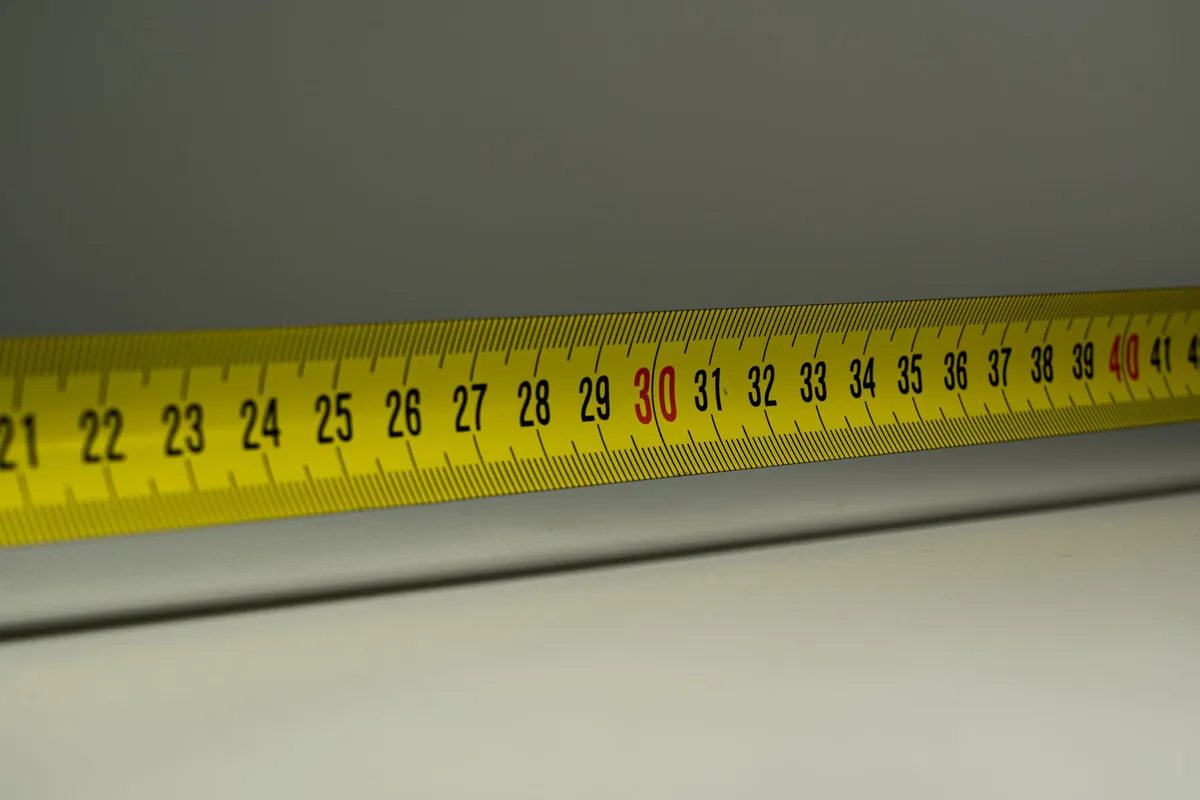 Close-up of a yellow measuring tape marked in centimetres