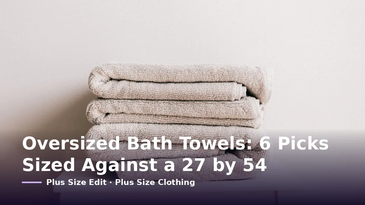 Cover card reading “Oversized Bath Towels: 6 Picks Sized Against a 27 by 54” over a stack of folded beige towels on a white stool