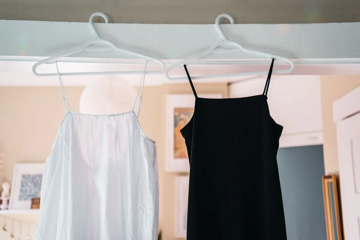 Black and white slip dresses hanging on a rail