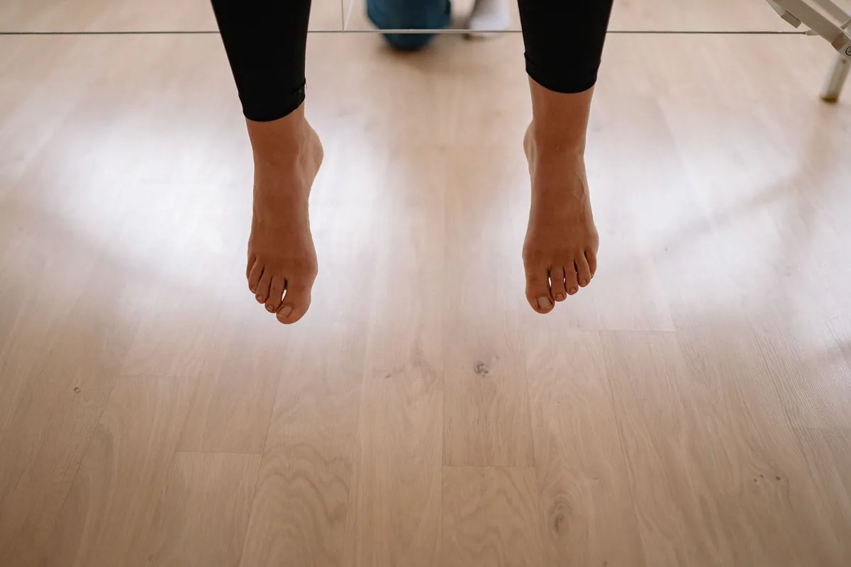 Bare feet on a light wooden floor